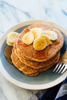 pancakes with bananas and syrup on a plate