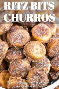 a bowl filled with sugared donuts on top of a wooden table