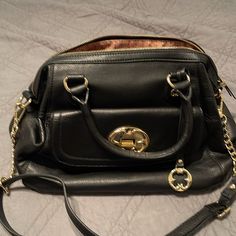 Beautiful Black Shoulder Bag,Never Been Used, No Tags But Is New. Black Travel Satchel With Metal Hardware, Black Satchel With Gold-tone Hardware For Office, Black Satchel With Metal Hardware For Travel, Black Office Satchel With Gold-tone Hardware, Office Black Satchel With Gold-tone Hardware, Black Office Satchel With Branded Hardware, Black Travel Satchel With Branded Hardware, Black Satchel With Branded Hardware For Travel, Black Satchel With Metal Hardware And Double Handle