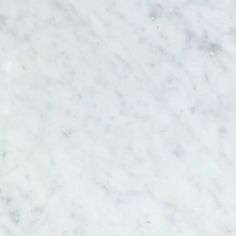 a white marble counter top with some black dots on it