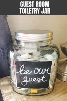 a jar filled with coins sitting on top of a wooden table