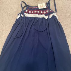 Brand New With Tags And Super Soft! This Navy Dress Has Shoulders That Can Be Tied To Fit Your Little One. Smocked Detailed Stars And Ruffles! Casual Smocked Dress With Smocked Back For Playtime, Sleeveless Smocked Dress For Playtime, Sleeveless Smocked Dress With Smocked Back For Playtime, Casual Dress With Smocked Back For Playtime, Blue Cotton Smocked Sundress, Blue Cotton Smocked Playtime Dress, Blue Smocked Dress With Smocked Cuffs For Playtime, Blue Smocked Dress With Cuffs For Playtime, Blue Cotton Smocked Dress For Vacation