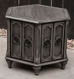 an old wooden side table with two doors