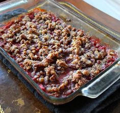 a casserole dish with crumbled toppings in a glass baking dish