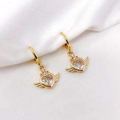 "This listing is for one pair of gold plated cubic zirconia heart angel wing charm earrings with gold plated mini huggie hoops. Great for sensitive ears! Earrings are about 0.75\" in total length." Trendy Cubic Zirconia Huggie Earrings As Gift, Trendy Cubic Zirconia Hoop Earrings For Gift, Angel Wings Jewelry For Anniversary, Angel Wings Heart, Angel Wing Earrings, Toggle Necklace, Unisex Necklace, Wing Earrings, Chain Choker Necklace