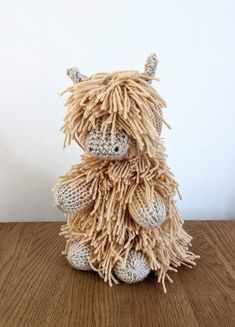 a stuffed animal sitting on top of a wooden table