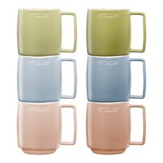 four pastel mugs with the word staub on them in different colors