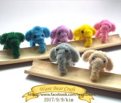 small stuffed animals are sitting on wooden trays