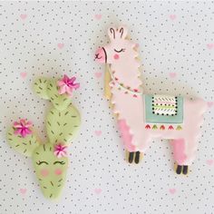 two decorated llamas next to a cactus on a polka dot wallpaper background