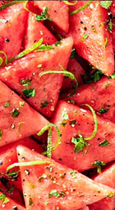 sliced watermelon in a white dish with herbs and seasoning on the side