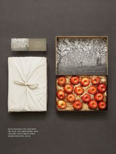 an open box with apples in it next to a white napkin and some other items