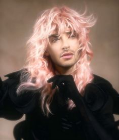 a man with long pink hair and black clothes