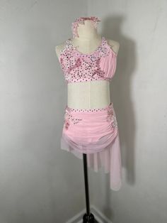 a pink and white dress on a mannequin