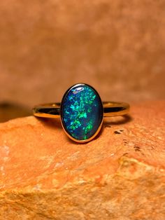 This classic doublet opal ring is from the heart of the Australian outback and was mined in the Coober Pedy, South Australia. Our jewellery is all handmade and each opal is cut by us in our Coober Pedy workshop.  This 9k gold bezel ring features a beautiful doublet opal with flashy colours of blue, green and turquoise reminding us of the most vivid blue ocean water. Opal is lively and kicks flashes from all angles and is a bright stone. Opal doublets are a slice of crystal or light opal assemble Water Opal, Australian Opal Ring, Green And Turquoise, Australian Outback, Types Of Opals, Coober Pedy, Bezel Ring, Ocean Water, Lightning Ridge