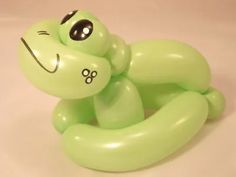 an inflatable frog toy sitting on top of a table