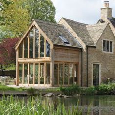 a large house sitting next to a body of water