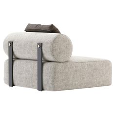 a gray couch with black legs and a pillow on it