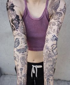 a woman with many tattoos on her arms