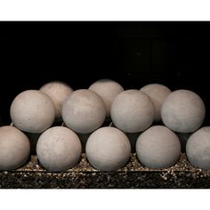 a bunch of white eggs sitting on top of each other in a pile next to one another