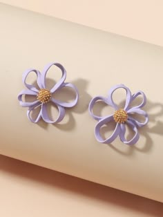 pair of purple flower earrings on white background