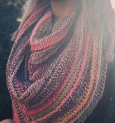 a woman wearing a multicolored knitted scarf