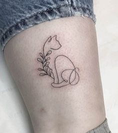 a small cat tattoo on the leg