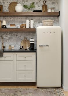 a white refrigerator freezer sitting inside of a kitchen