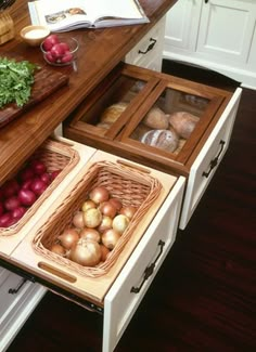 an open drawer in the middle of a kitchen filled with fruits and vegetables, including radishes