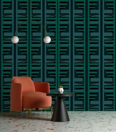 a chair and table in front of a green wall with geometric designs on it's sides