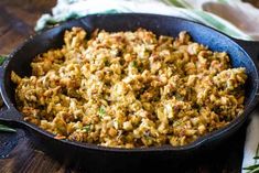 a pan filled with food sitting on top of a wooden table