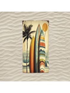 an image of surfboards on the beach with palm trees and sun in the background