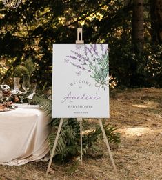 a sign that says welcome to america on it next to a table with flowers and greenery