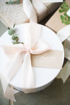 a white plate topped with a pink bow and a tag on it's side