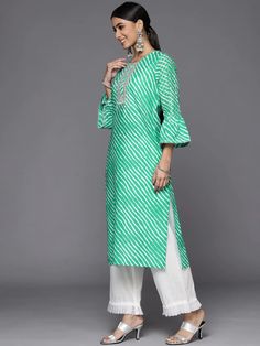 This is a single piece kurta. It comes with straight shape kurta comes with floral print detailing has round neck, 3/4th sleeves & calf length. Single Piece Color-Green Suit Fabric-Cotton Work - Leheriya Print & Gota Patti Detailing Neck-Round Neck Sleeves-3/4th Flared Sleeves Kurta Length - Calf Length Washing Care - Hand Wash Size worn by the model: Small Height: 5'7" Green Suit, Suit Fabric, Green Cotton, Indian Wear, Straight Cut, Flared Sleeves, Single Piece, Fabric Cotton, Indian Fashion