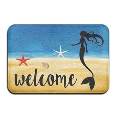 a welcome mat with a mermaid and starfish on the beach