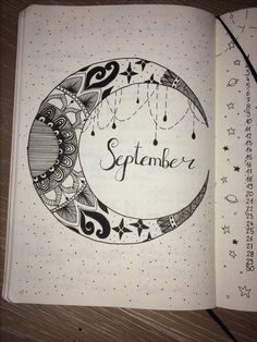 an open notebook with the word november written on it and a drawing of a crescent