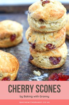 some scones are stacked on top of each other with cranberry toppings