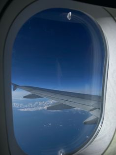 an airplane window looking out at the ocean