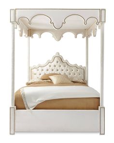 a white bed with an ornate headboard and foot board on top of the bed