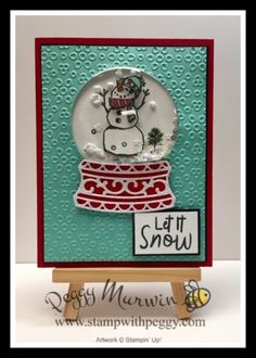 a card with a snow globe on it and the words let it snow written in white