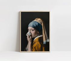 a painting of a girl with a pearl earring holding an object in her hand