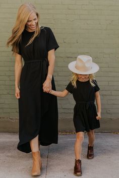 Your favorite ROOLEE dress now comes in a mini! Perfect for flower girls, any special occasions, or church, this faux wrap dress is designed with cuffed sleeves, buttoned keyhole in the back, elastic around the waist, and a removable tie waistband. Shop the rest of the Collection: Mommy + Me Available in Plum, Black, Navy, Olive, Natural, and Blush Baby and Toddler sizes do not have a wrap skirt Lined Mommy and me style - match with your little one! Jane Dress, Skirt Jumpsuit, Baby And Toddler, Plus Size Shopping, Flower Girls, Faux Wrap Dress, Swimsuit Cover, Toddler Sizes