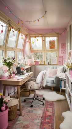 a home office with pink walls and lots of bookshelves, windows, and rugs