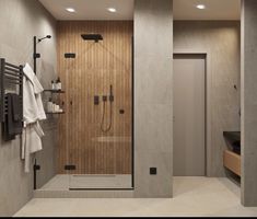 a bathroom with a walk in shower sitting next to a sink and a towel rack