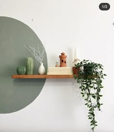 two potted plants are sitting on a shelf next to a vase and other items