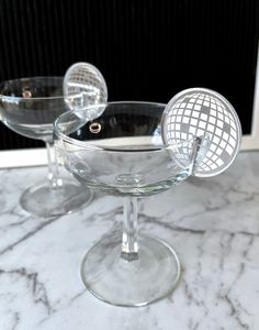 two wine glasses sitting on top of a marble counter