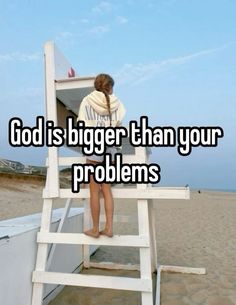 a woman sitting on top of a lifeguard chair with the words god is bigger than your