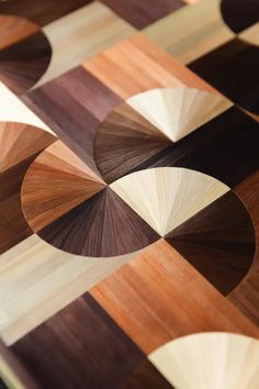 a close up view of wood flooring with circles and squares on the top one