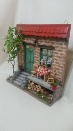 a miniature house with a table and chairs