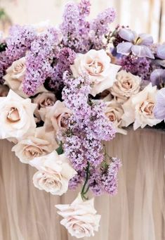 a bouquet of purple and white flowers in a vase